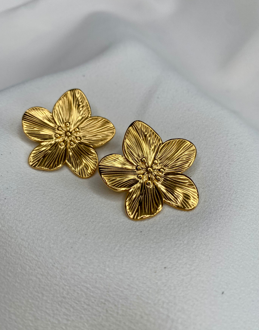 Close-up of ABYDOS Big Flower Statement Earrings, featuring intricate five-petal floral designs crafted from high-quality 18k gold-plated stainless steel. Perfect for elegant, chic, and timeless looks, ideal as a bold statement accessory or gift.