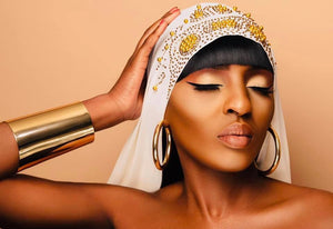 Model wearing Jarlia By Jolina’s Signature Collection, featuring a bold gold hoop earrings, statement jewellery, and intricate bracelet. These handcrafted pieces embody elegance and cultural heritage. Explore the collection today.