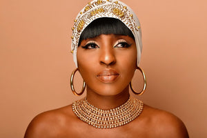 Model wearing Jarlia By Jolina’s beaded jewellery, featuring a multi-layered gold choker and bold hoop earrings. Paired with an embellished headscarf, this look exudes elegance and heritage. Explore the Beaded Jewellery Collection at Jarlia By Jolina.